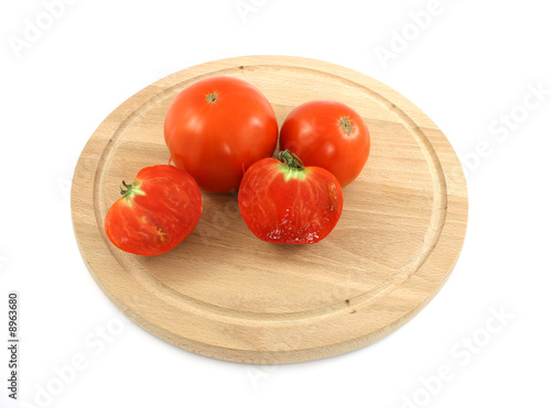 fresh red tomatoes on wooden plate