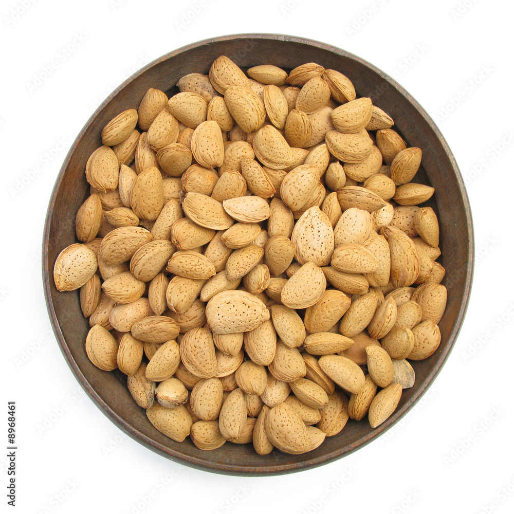 Almonds cork nuts in wooden dish Almonds cork nuts in wooden dish