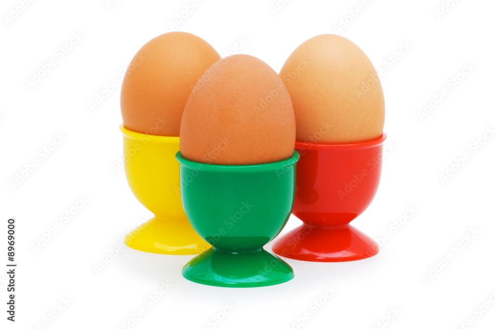 Brown egg in holder isolated on white