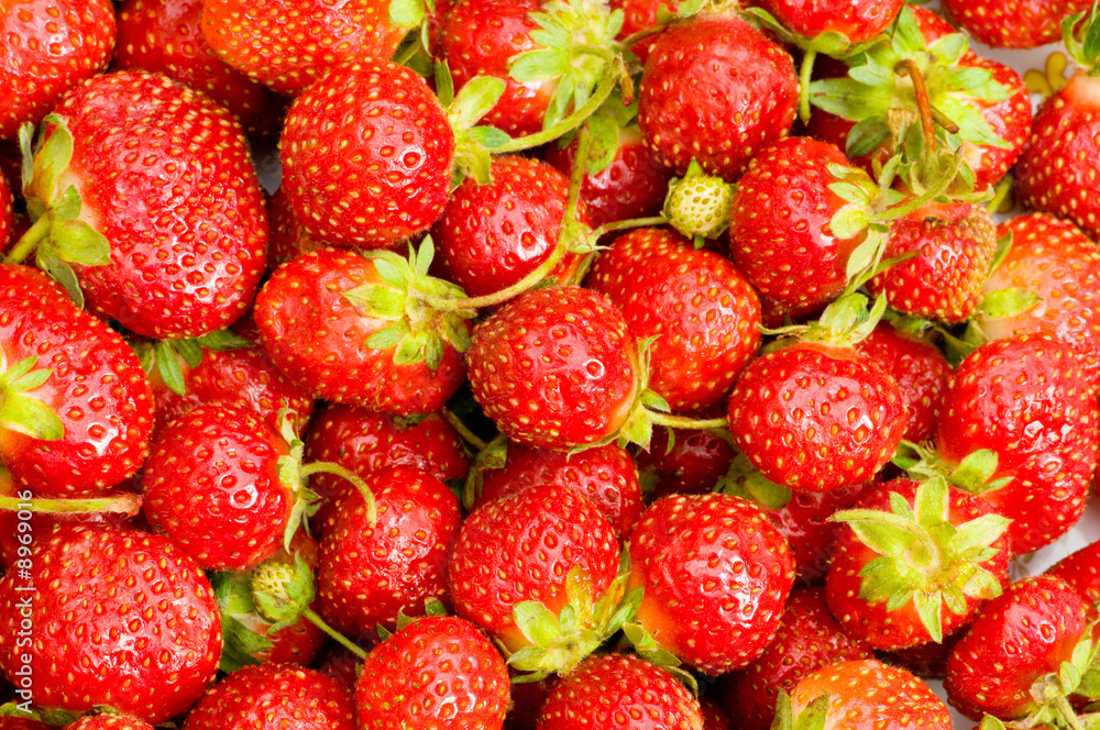 Fruit concept - red strawberries arranged as background Fruit concept - red strawberries arranged as background