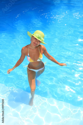 Young woman standing  in a swimming pool