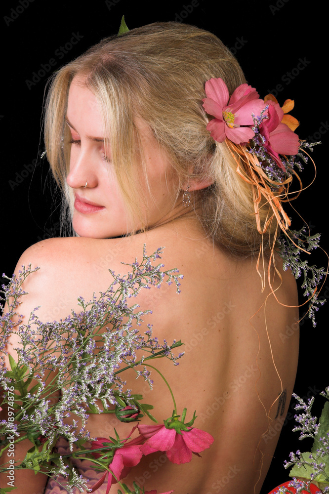 Naklejka premium Beautiful young blond model with flowers in her hair