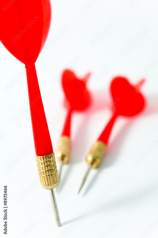 three red darts on a white surface three red darts on a white surface