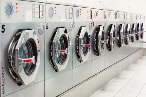 A row of industrial washing machines