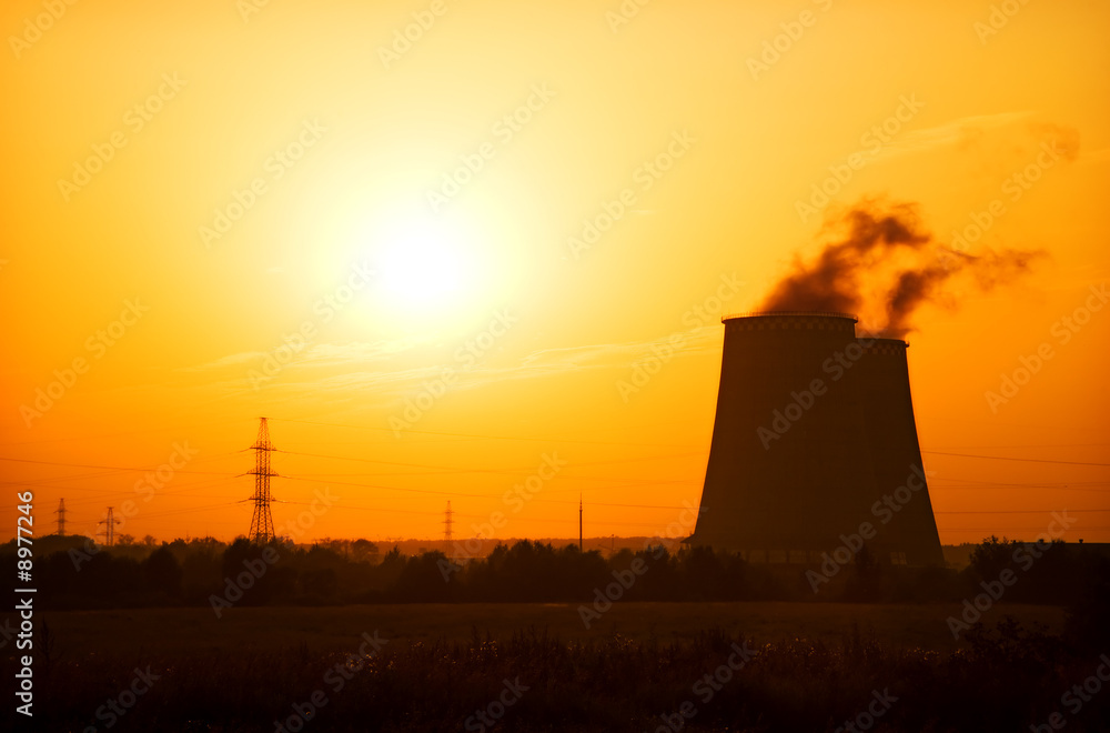 Heat and power plant on red sunset background.
