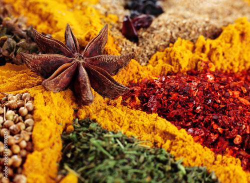 Fototapeta Mix spice background with anise star and curcuma closeup