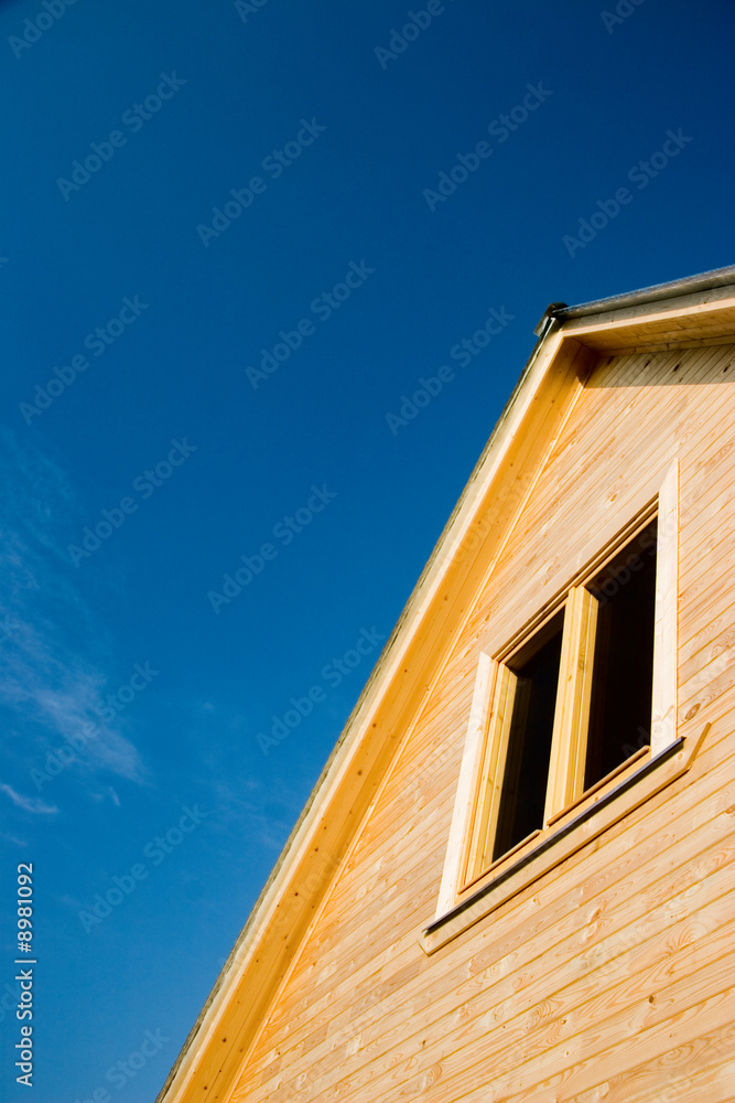 Wooden house roof. Clear deep blue sky background. Wooden house roof. Clear deep blue sky background.
