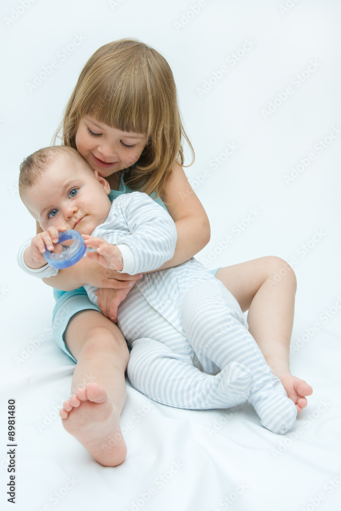 little brother and sister playing together, on white little brother and sister playing together, on white