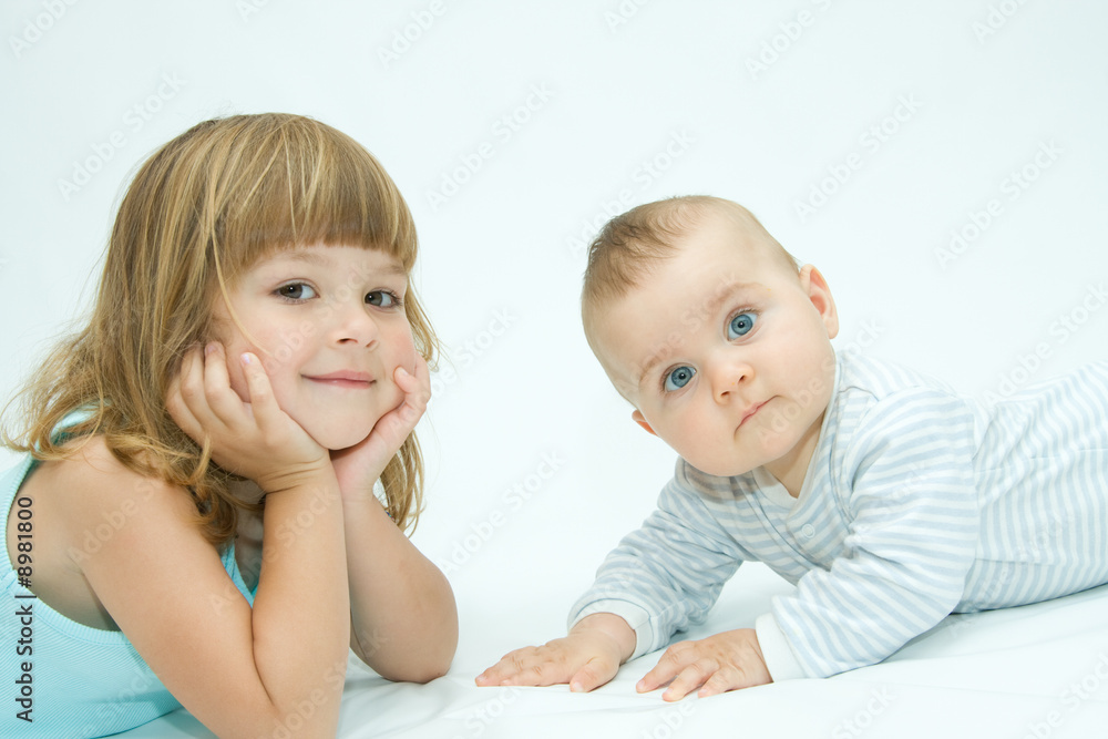 little brother and sister playing together, on white little brother and sister playing together, on white