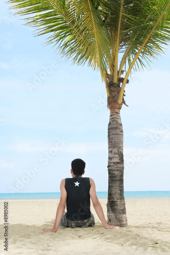 enjoy and relax on tropical beach under coconut tree