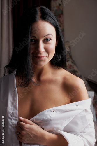 Young adult Caucasian woman in a white mens shirt