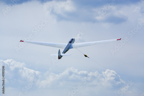 two-seated glider lifted into the sky by a winch
