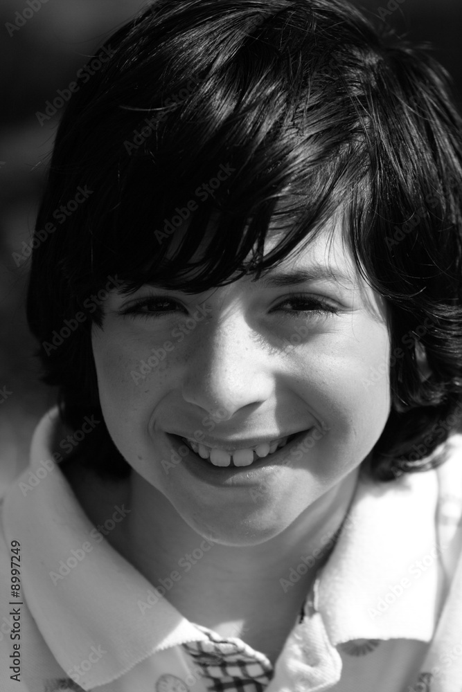 Black and white image of a young boy smiling Black and white image of a young boy smiling