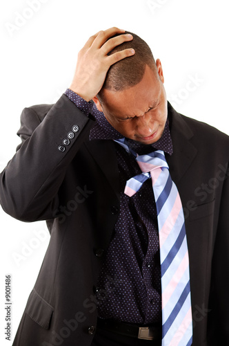 This is an image of a businessman with his hands to his head. photo