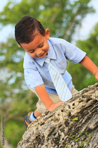Young child climbing a rock