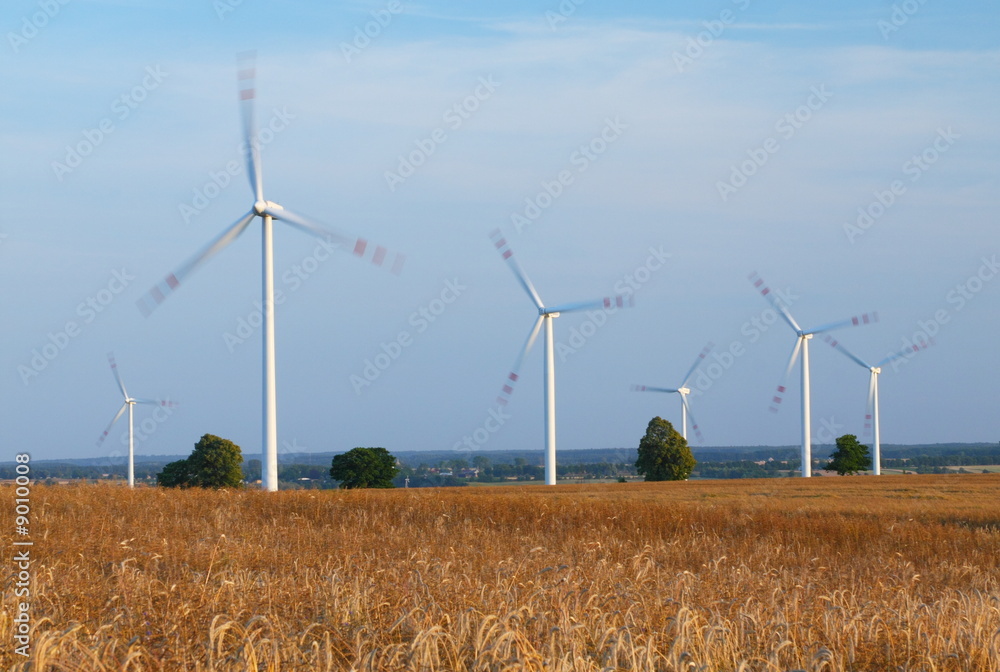 Power generating wind turbines, blurred to show quick movement Power generating wind turbines, blurred to show quick movement
