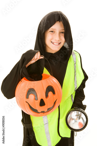 Adorable little boy in his Halloween costume & safety gear photo