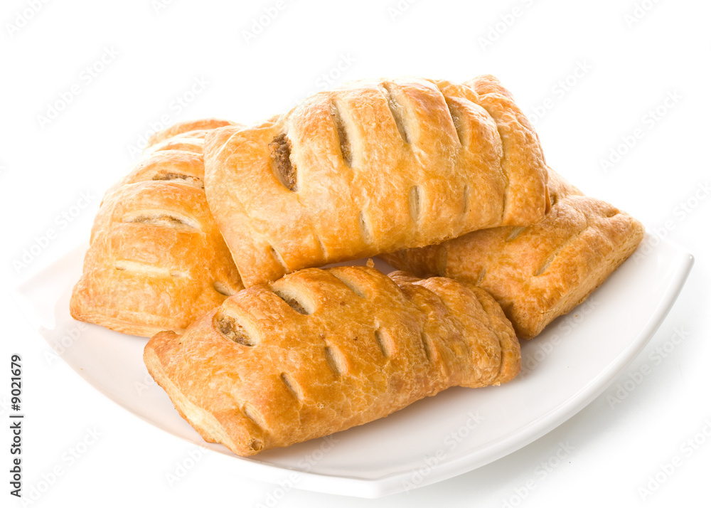 Fresh rolls on a plate on a white background