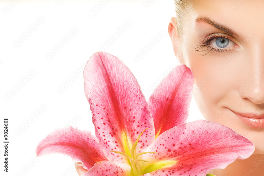 Beautiful young woman with pink lily close-up portrait Beautiful young woman with pink lily close-up portrait