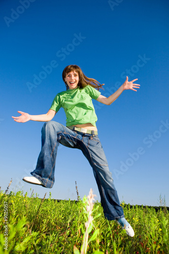 Happy young woman enjoying summer. Jumping.