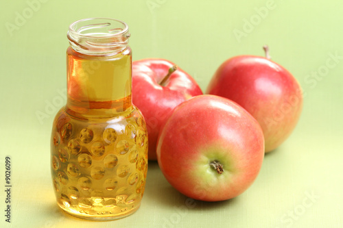 bottle of apple juice and some fresh apples
