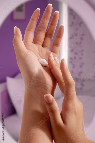 woman hands applying moisturizing cream to her skin.