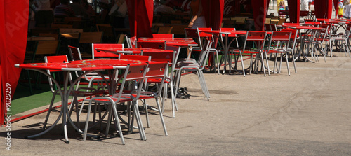 Cafe with metallic chairs and tables in the street