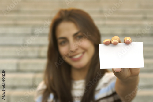 Young girl holding a blank business card
