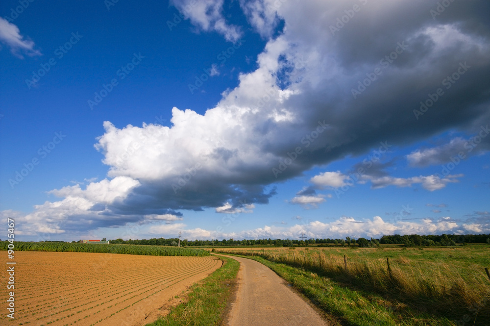 dramatic thunder clouds above a rural scene