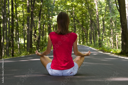 Girl doing yoga in the forest