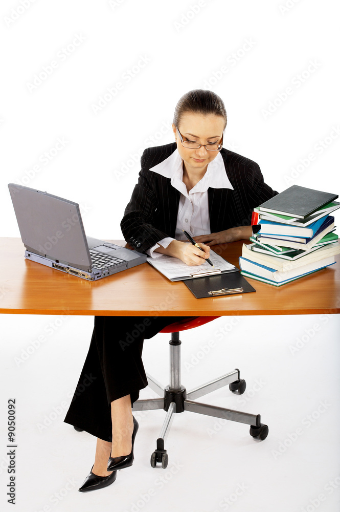 businesswoman with laptop and books seating at the table businesswoman with laptop and books seating at the table