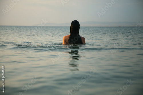 South landscape. Dark-haired girl in the sea © Egor Mayer