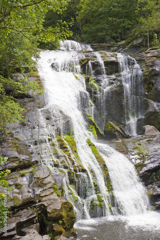 A waterfall flowing over rocks and moss