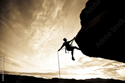 Rock climber rappelling. © Greg Epperson