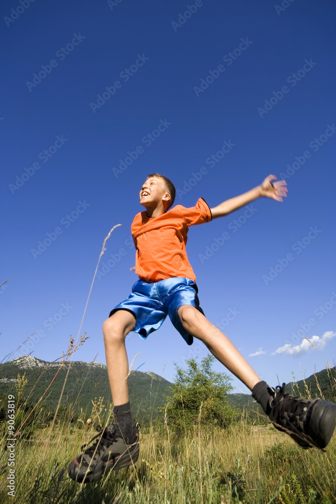 Young boy having jumping and having fun outdoor Young boy having jumping and having fun outdoor