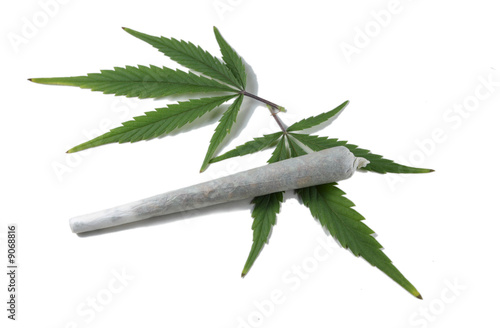 Marihuana cigarette with two cannabis leafs isolated