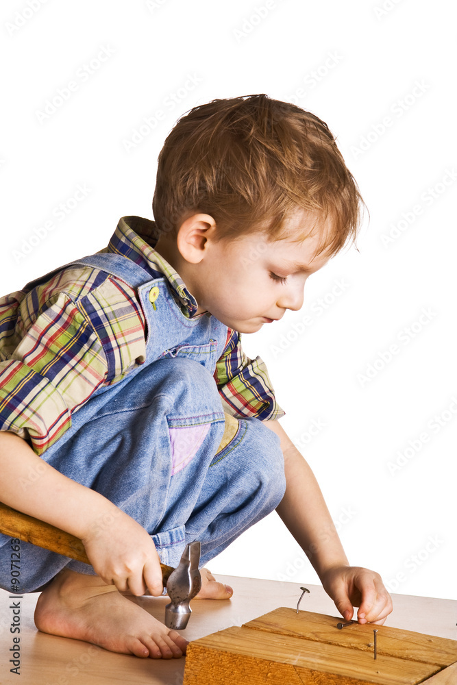 Child studies to hammer in nails Child studies to hammer in nails
