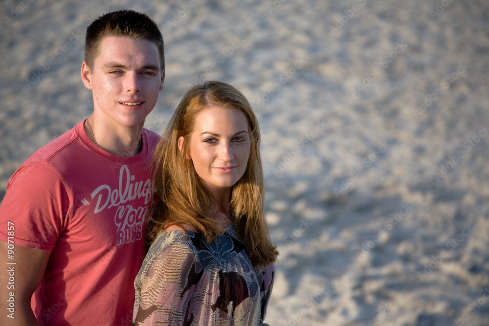 Loving couple on the beach, enjoying their summer holiday Loving couple on the beach, enjoying their summer holiday