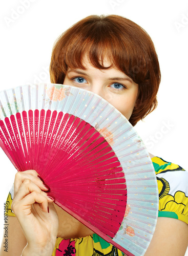 Happy young girl with fan over white