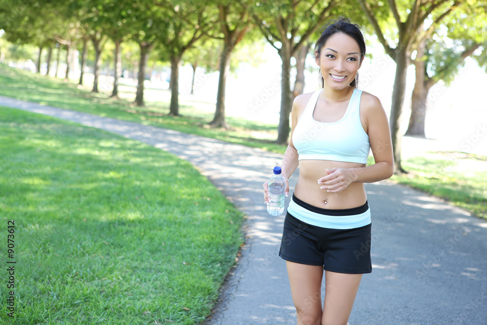 A young pretty asian woman jogging in the park