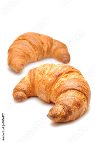 Two fresh croissant isolated over white background