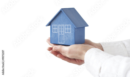 Model house held by female hands