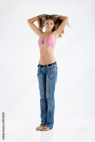 Teen age girl in a blue jeans and pink top