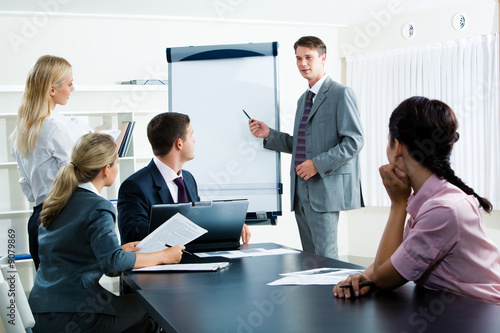 Image of smart business people looking at their leader photo