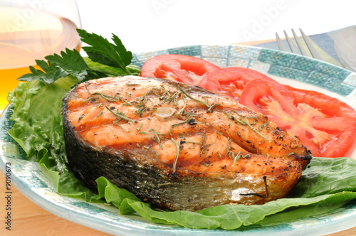 Salmon steak grilled to perfection with fresh vegetables.