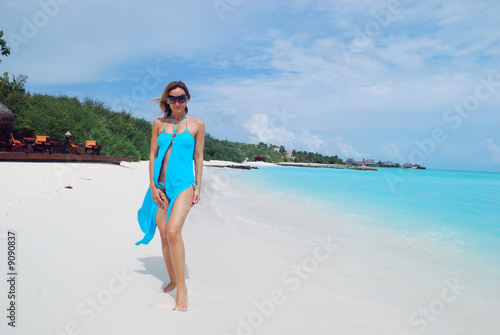happy woman walking on the tropical beach