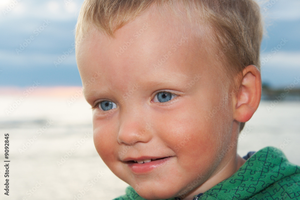 Small boy portrait on evening sandy sea coast Small boy portrait on evening sandy sea coast