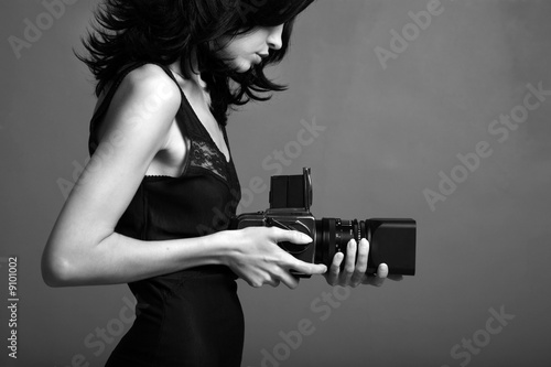 Fashion portrait of young photographing lady