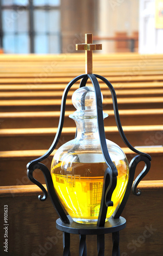 Cross and anointing oil inside a church.