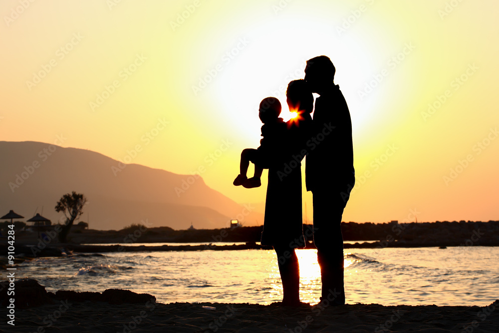 happy family of three on the beach silhouette